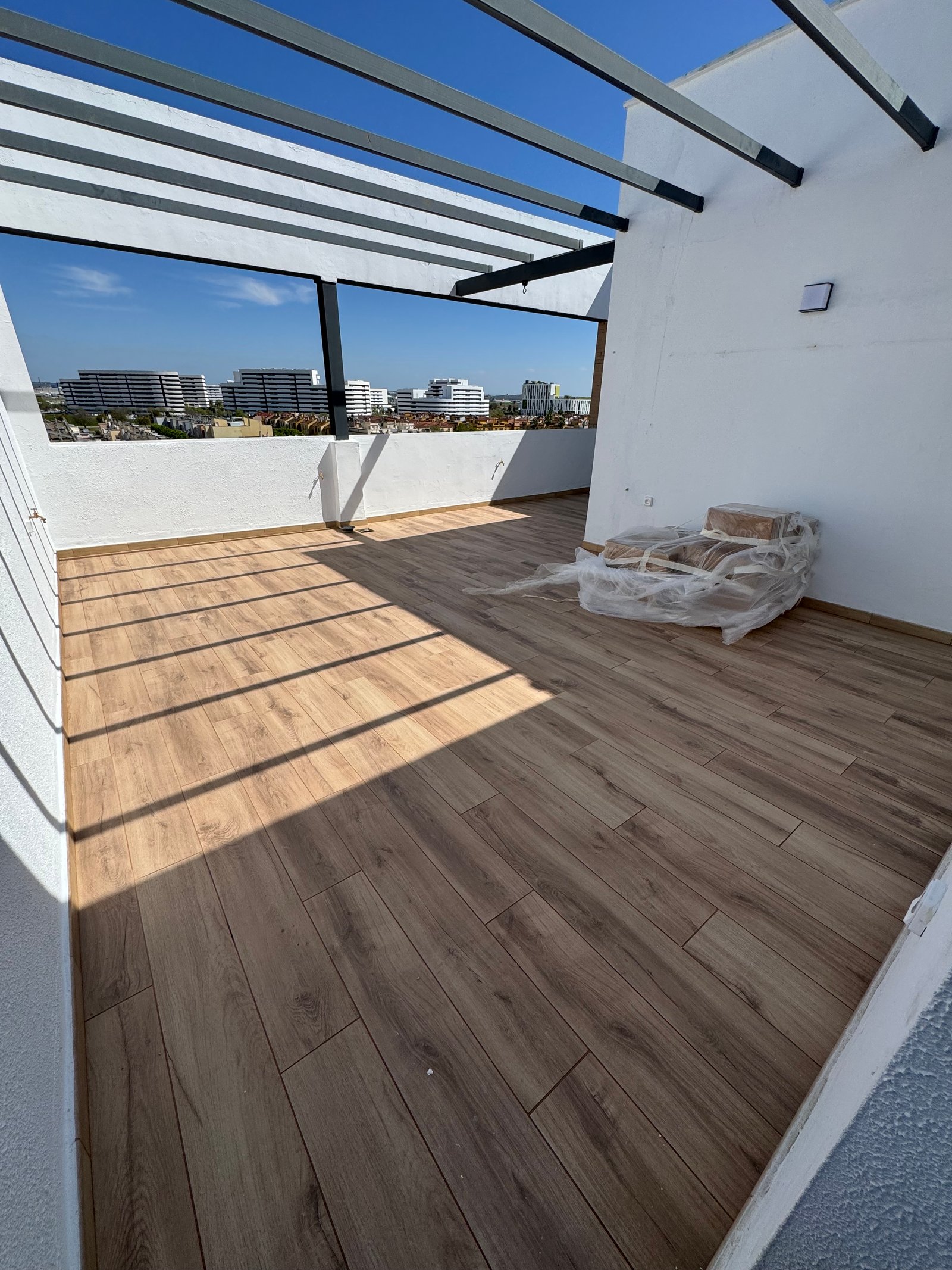 Suelo de porcelánico imitación madera en una terraza reformada en Sevilla